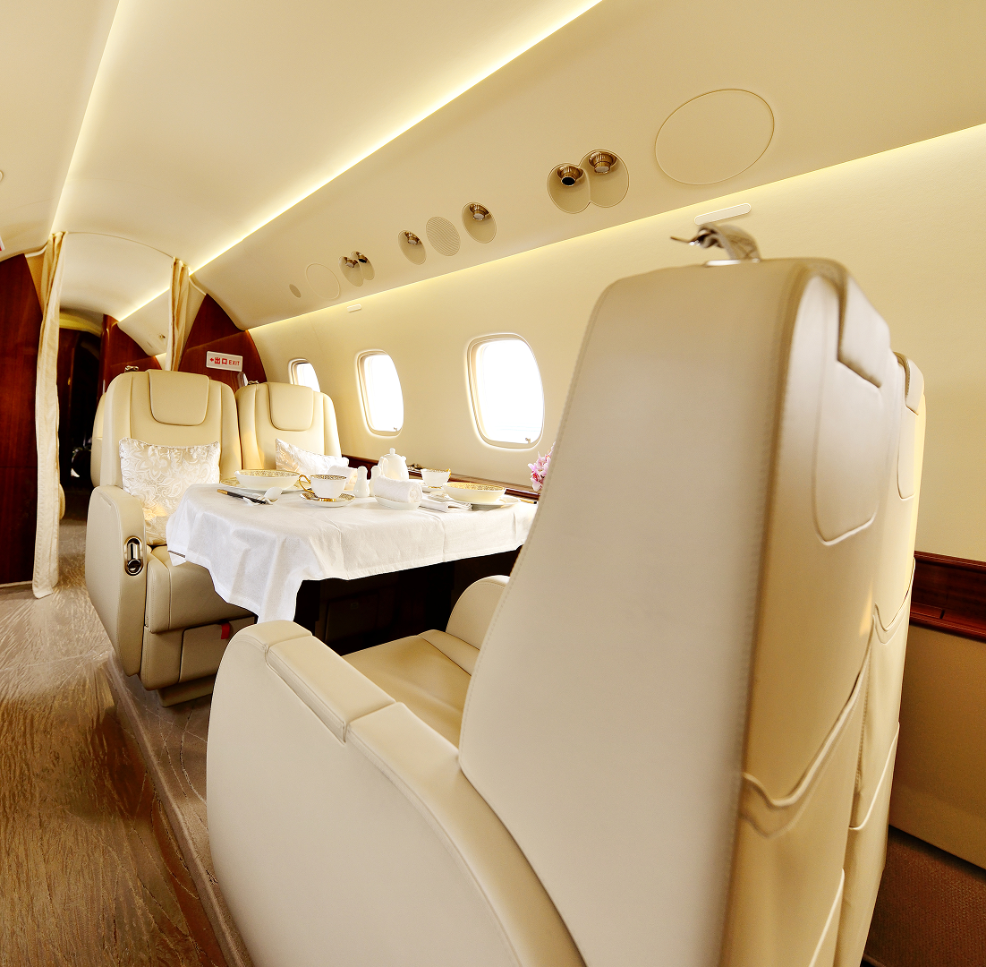 Luxurious private jet cabin with dining table